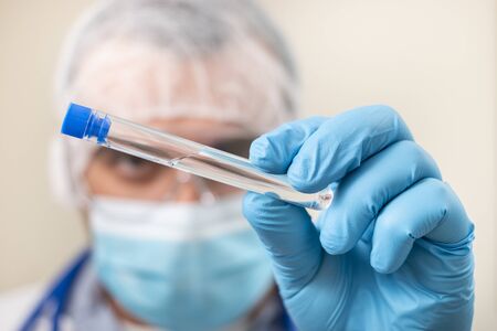 View of caucasian doctor with  test tube on a white background.