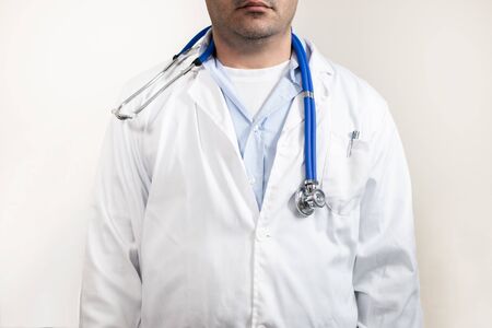 caucasian doctor with stethoscope and lab white coat isolated on a white background.の写真素材