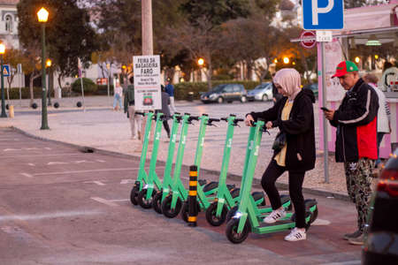 FARO, PORTUGAL: 16th FEBRUARY 2020 - Green electric scooters from Bolt company for rent parked on the city.のeditorial素材