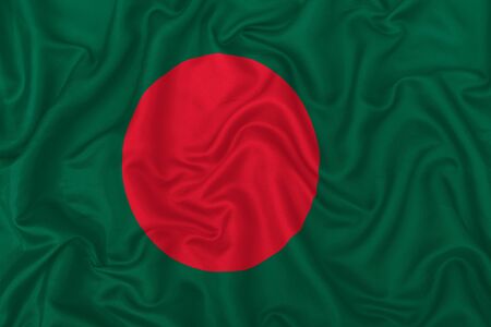 Bangladesh country flag on wavy silk textile fabric background.の写真素材