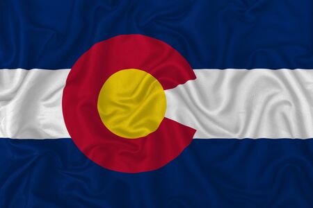Colorado state flag on a wavy silk satin fabric texture background.