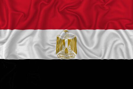 Egypt country flag on wavy silk textile fabric background.の写真素材