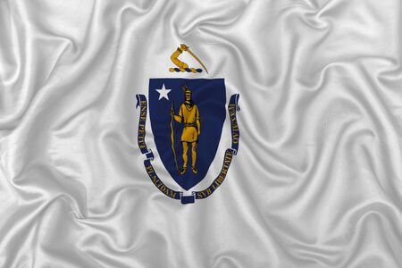 massachusetts state flag on a wavy silk satin fabric texture background.の写真素材