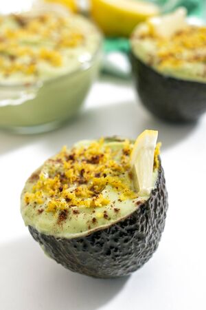 Fresh and tasty dessert of avocado pear sweet cream with lemon.