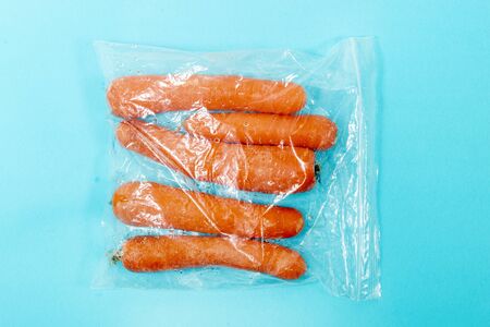 fresh organic vegetable carrots from the grocery market on a plastic bag.の写真素材