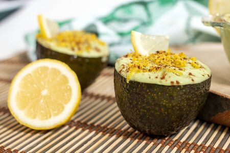 Fresh and tasty dessert of avocado pear sweet cream with lemon.