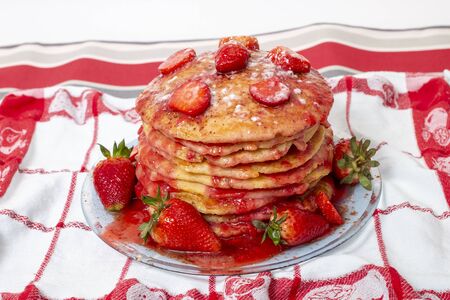 Delicious oats and banana pancakes with strawberries fruits and sauce.の写真素材