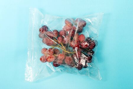 fresh organic grapes fruit from the grocery market on a plastic bag.の写真素材
