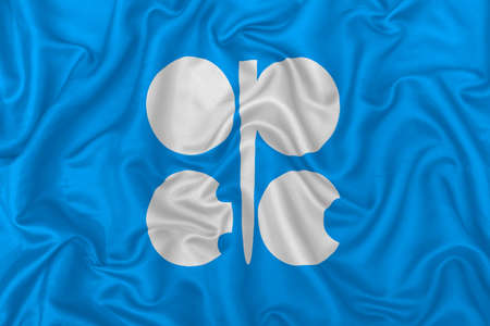 Organization of the Petroleum Exporting Countries (OPEC) flag on wavy silk textile fabric background.のeditorial素材