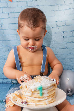 Party for one year baby boy with a set composed of balloons, ribbons, and brick wall paper and pancakes.の写真素材