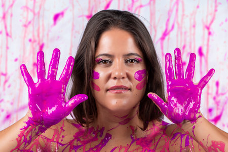 girl with pink and white swirl body painting on breasts, on a white background.
