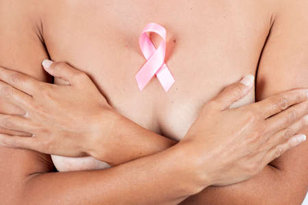 Close view of woman with pink breast awareness cancer ribbonの写真素材