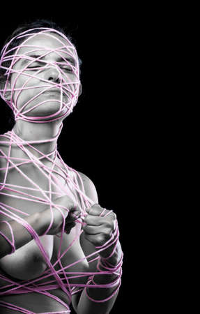 Young woman with little pink jewel gems covering her breasts, symbolizing the fight for breast cancer awareness.の写真素材