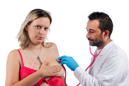 doctor examining woman breast with stethoscope for lumps or other anomalities.の写真素材