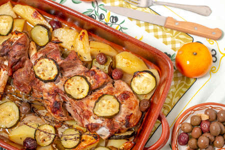 Typical portuguese meal of Roasted lamb with potato and zucchini.の写真素材