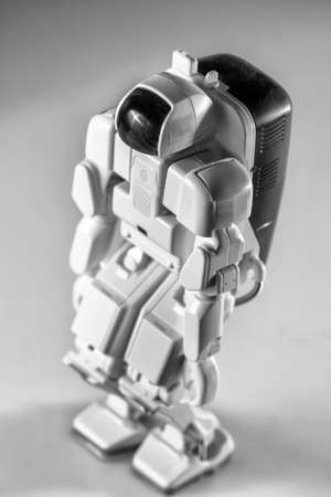 Modern advanced autonomous robot toy isolated on a gray background.の写真素材