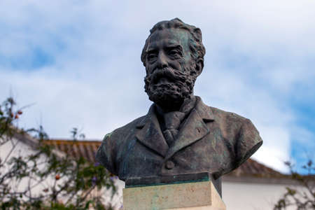 FARO, PORTUGAL: 20th june 2021 - Garden Manuel Bivar bust statue of Joao de Deus poet in Faro city, Portugal.のeditorial素材