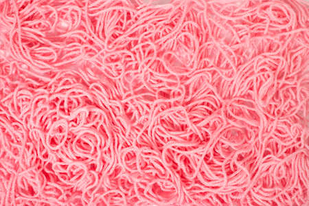 Pile of a pink tangled knitting yarn of wool.の写真素材