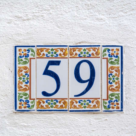 Typical architecture of Algarve vintage style house numbers, located in Olhao, Portugal.