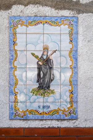 SANTA RITA, PORTUGAL - 1st MAY 2022: Handpainted azulejo artwork depicting a countryside village saint of Santa Rita.のeditorial素材