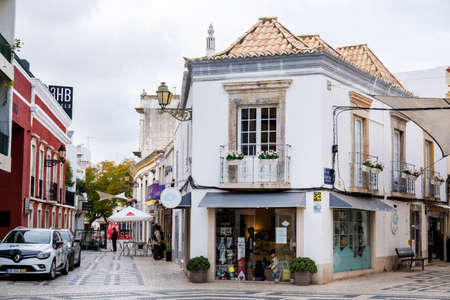 FARO, PORTUGAL - 12th FEBRUARY 2022: Tourist downtown shop area in Faro city with cobblestone streets and cute tiny business.のeditorial素材