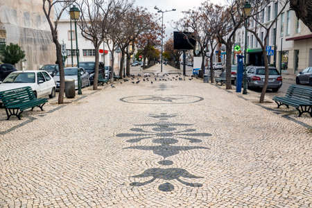 Long view of the Republic main avenue on Olhao city, with beautiful cobblestone artwork, Algarve,...