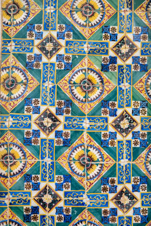 Traditional azulejo artwork with floral design of Portuguese houses and decorations.