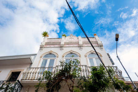 Typical architecture of Algarve rustic buildings with intricate designs of platbands.の写真素材