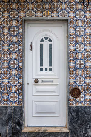 Typical architecture door with intricate design details of traditional Portuguese buildings.の写真素材