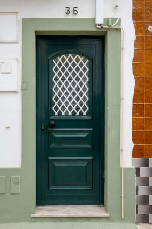 Typical architecture door with intricate design details of traditional Portuguese buildings.の写真素材
