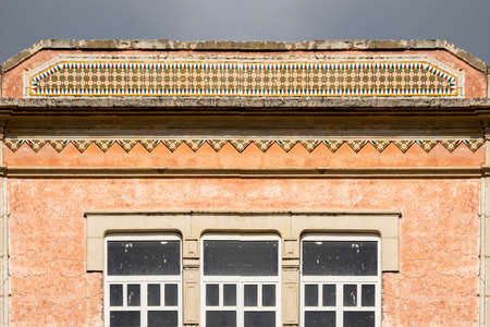 Typical architecture of Algarve rustic buildings with intricate designs of platbands.の写真素材