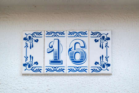 Beautiful house number sixteen in azulejo tile, typical of Portuguese houses.の写真素材