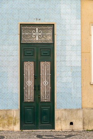 Typical architecture door with intricate design details of traditional Portuguese buildings.の写真素材