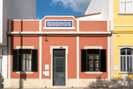 Typical architecture of Algarve rustic buildings with intricate designs of platbands.の写真素材