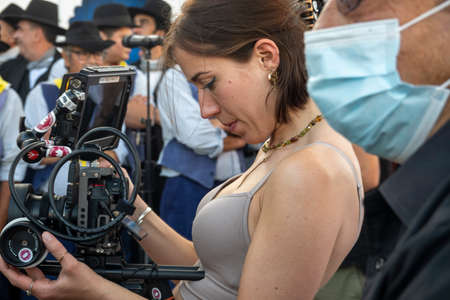 MERTOLA, PORTUGAL - 22nd MAY 2022: Woman operating a professional camera on an outdoor event.