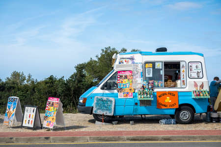 LAGOA, PORTUGAL - 24th APRIL 2022: Localice cream and natural fresh orange juice van salesman near a beach.のeditorial素材