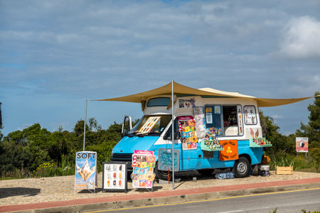 LAGOA, PORTUGAL - 24th APRIL 2022: Localice cream and natural fresh orange juice van salesman near a beach.のeditorial素材