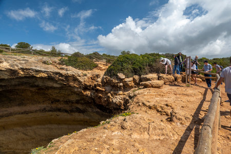 BENAGIL, PORTUGAL - 24th APRIL 2022: Natural geologic sink hole formation in the Algarve region near the coastline, Lagoa, Portugal.のeditorial素材