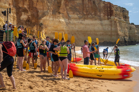 BENAGIL, PORTUGAL - 24th APRIL 2022: Group of people prepare for kayaking in the beach of Benagil.のeditorial素材
