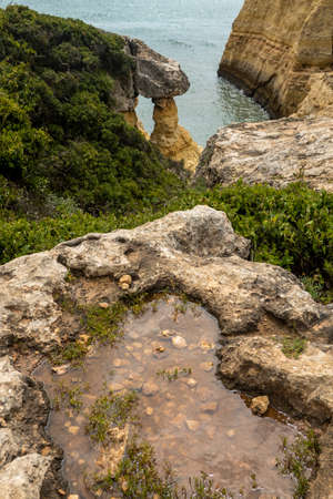 Natural sand formed by erosion of the elements located in the shoreline cliffs of the Algarve region, Portugal.の写真素材