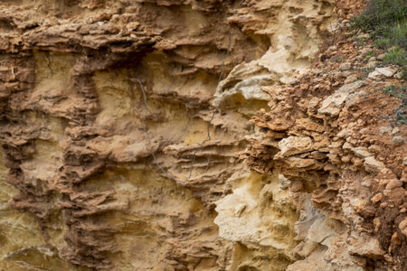 Natural sand formed by erosion of the elements located in the shoreline cliffs of the Algarve...