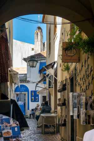 SINTRA, PORTUGAL - 27th JUNE 2022: Narrow streets of Sintra village with various businesses, including restaurants and souvenirs.のeditorial素材