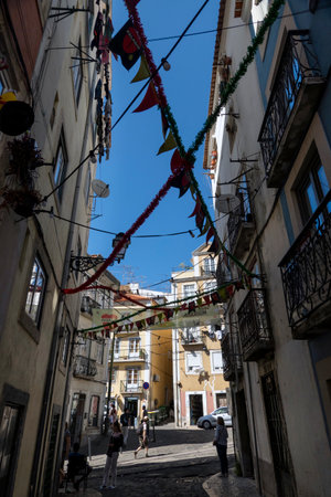 LISBON, PORTUGAL - 28th JUNE 2022: People and tourists visit and enjoy the Mouraria district, the old town in Lisbon, Portugal.のeditorial素材
