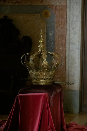 MAFRA, PORTUGAL - 29th JUNE 2022: Royal golden crown over a red cloth stand at display on the convent of Mafra, Portugal.のeditorial素材