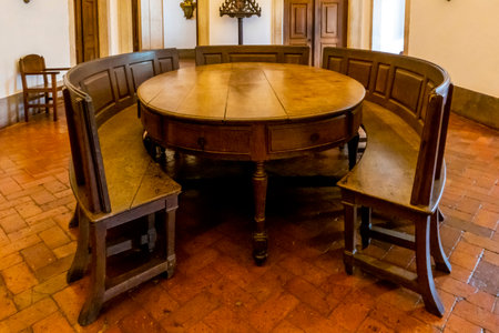 MAFRA, PORTUGAL - 29th JUNE 2022: View of a beautiful and highly luxurious large room with wooden round table used by monks for gathering and recreation on the Palace of Mafra, Portugal.のeditorial素材