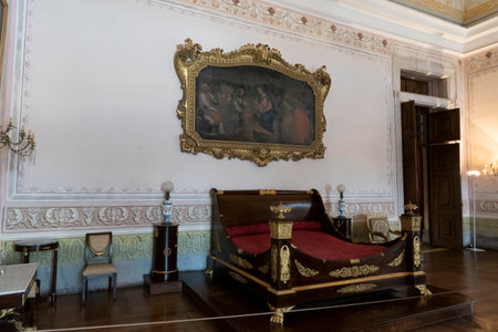 MAFRA, PORTUGAL - 29th JUNE 2022: Close up view of an ancient highly detailed wooden bed at display on the convent of Mafra, Portugal.のeditorial素材