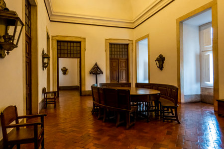 MAFRA, PORTUGAL - 29th JUNE 2022: View of a beautiful and highly luxurious large room with wooden round table used by monks for gathering and recreation on the Palace of Mafra, Portugal.のeditorial素材