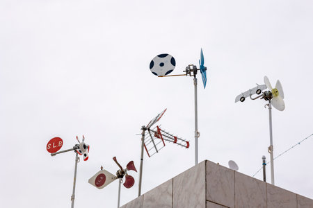 View of several wind direction windmills on top of balcony.