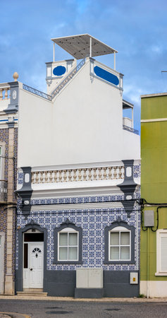 Typical Portuguese house details from the Algarve, with detailed platbands and colorful azulejo tiles.の写真素材