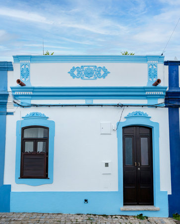 Typical architecture of Algarve rustic buildings with intricate designs of platbands.の写真素材